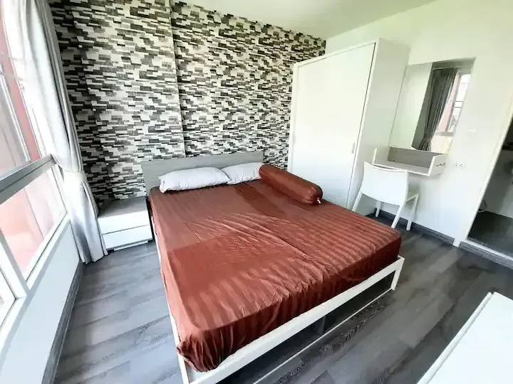 Comfortable bedroom with double bed and stylish feature wall